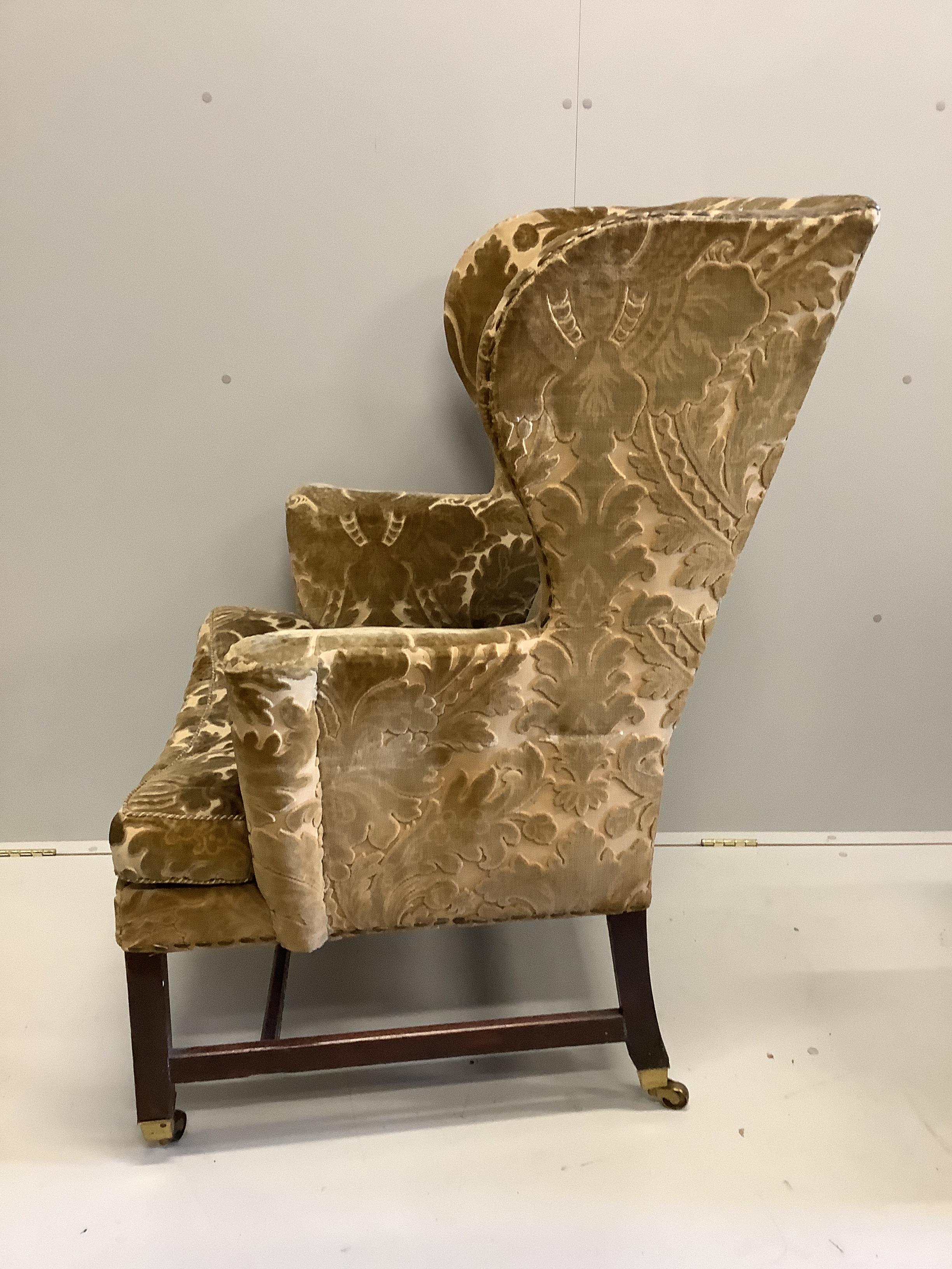 A George III mahogany velvet brocade wingback armchair, for use by Edward VII, width 84cm, depth 76cm, height 116cm